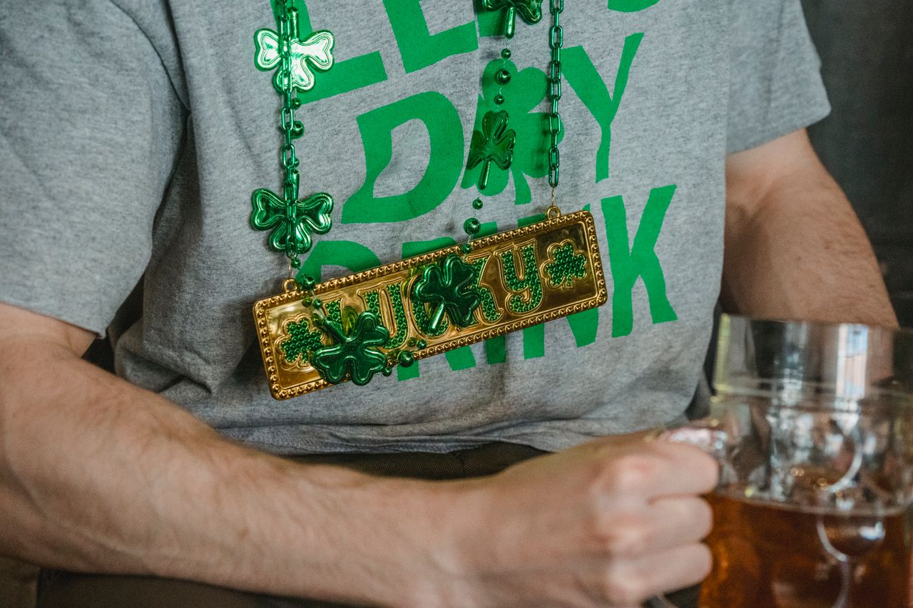The Art of Drawing Readers In: Your attractive post title goes here Close-up of St. Patrick's Day shirt and accessories with a beer mug, capturing the festive spirit.